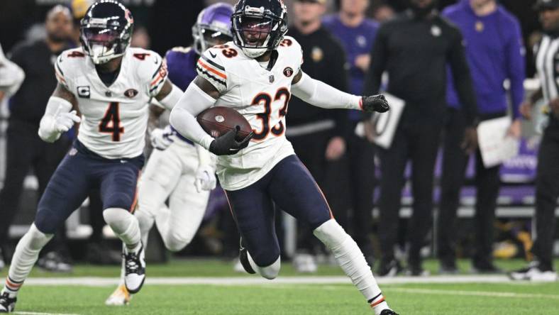 Nov 27, 2023; Minneapolis, Minnesota, USA; Chicago Bears cornerback Jaylon Johnson (33) returns an interception as safety Eddie Jackson (4) looks on against the Minnesota Vikings during the second quarter at U.S. Bank Stadium. Mandatory Credit: Jeffrey Becker-USA TODAY Sports