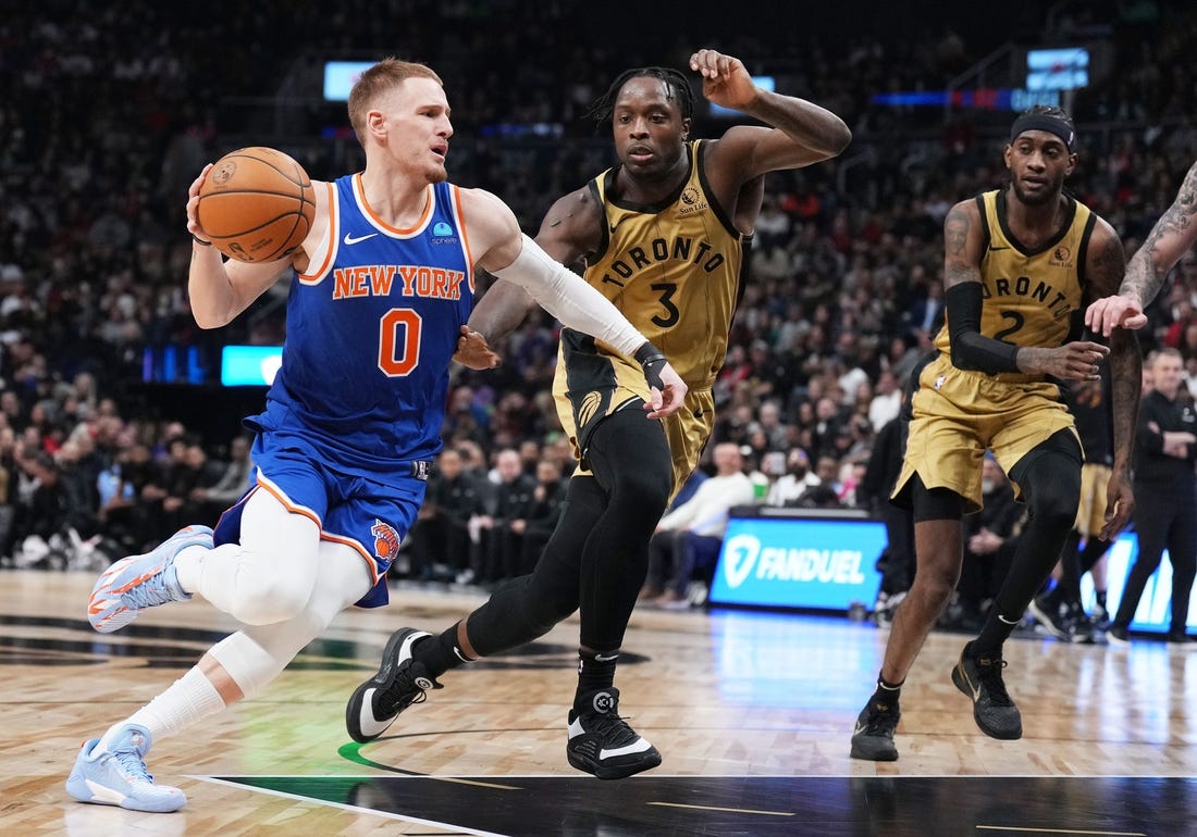 Dec 1, 2023; Toronto, Ontario, CAN; New York Knicks guard Donte DiVincenzo (0) controls the ball as Toronto Raptors forward O.G. Anunoby (3) tries to defend during the second quarter at Scotiabank Arena. Mandatory Credit: Nick Turchiaro-USA TODAY Sports