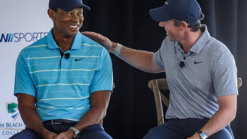 Tiger Woods and Rory McIlroy talk with Erin Andrews during a morning media event before groundbreaking ceremony at Palm Beach State College in Palm Beach Gardens, Fla., on February 20, 2023. It will be the future site of TGL, a new golf league played in a stadium and launched in partnership with the PGA.