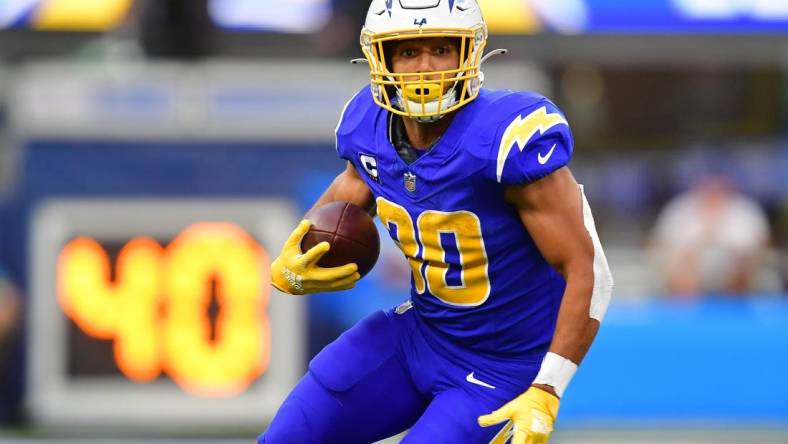 Dec 10, 2023; Inglewood, California, USA; Los Angeles Chargers running back Austin Ekeler (30) runs the ball against the Denver Broncos during the first half at SoFi Stadium. Mandatory Credit: Gary A. Vasquez-USA TODAY Sports