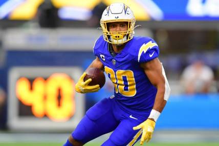 Dec 10, 2023; Inglewood, California, USA; Los Angeles Chargers running back Austin Ekeler (30) runs the ball against the Denver Broncos during the first half at SoFi Stadium. Mandatory Credit: Gary A. Vasquez-USA TODAY Sports
