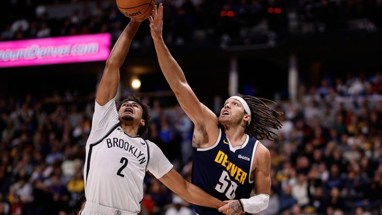 Dec 14, 2023; Denver, Colorado, USA; Brooklyn Nets forward Cam Johnson (2) and Denver Nuggets forward Aaron Gordon (50) battle for the ball in the third quarter at Ball Arena. Mandatory Credit: Isaiah J. Downing-USA TODAY Sports