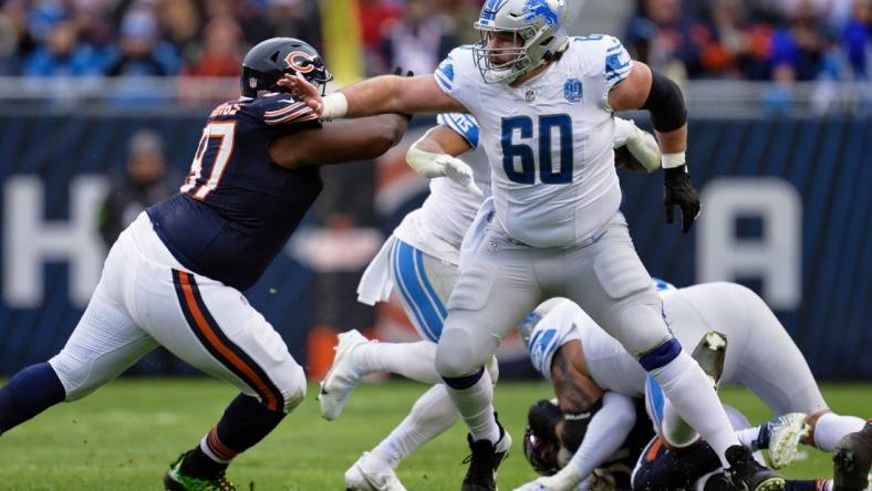 Dec 10, 2023; Chicago, Illinois, USA;  Detroit Lions offensive lineman Graham Glasgow (60) blocks against the Chicago Bears at Soldier Field. Mandatory Credit: Jamie Sabau-USA TODAY Sports