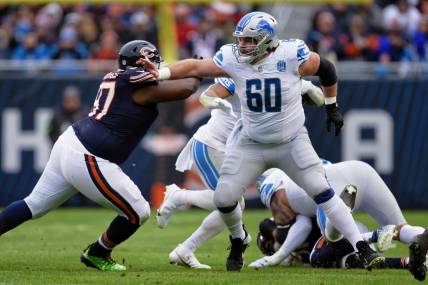 Dec 10, 2023; Chicago, Illinois, USA;  Detroit Lions offensive lineman Graham Glasgow (60) blocks against the Chicago Bears at Soldier Field. Mandatory Credit: Jamie Sabau-USA TODAY Sports
