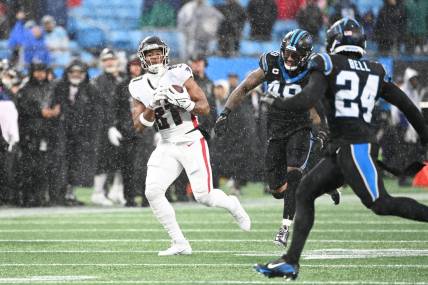 Dec 17, 2023; Charlotte, North Carolina, USA; Atlanta Falcons tight end Jonnu Smith (81) catches the ball as Carolina Panthers linebacker Frankie Luvu (49) and safety Vonn Bell (24) defend in the second quarter at Bank of America Stadium. Mandatory Credit: Bob Donnan-USA TODAY Sports