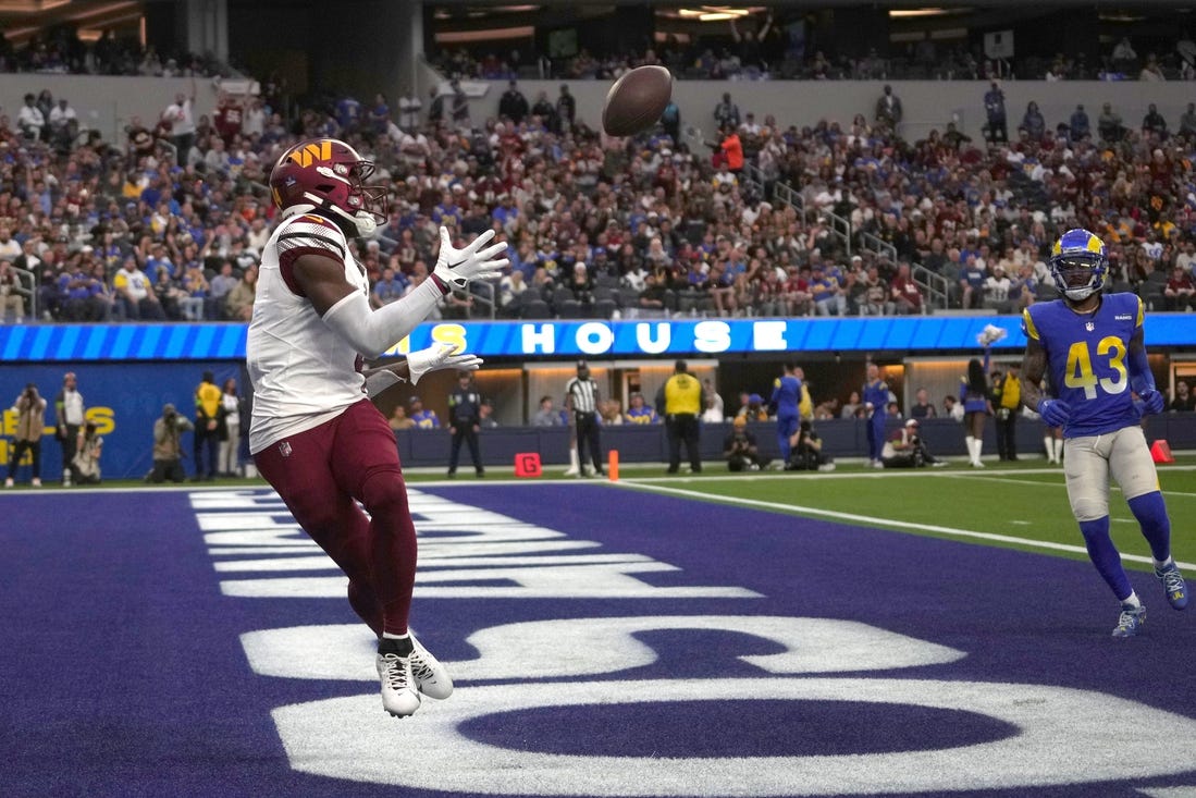 Dec 17, 2023; Inglewood, California, USA; Washington Commanders wide receiver Curtis Samuel (4) catches a touchdown pass in the second half against the Los Angeles Rams at SoFi Stadium. Mandatory Credit: Kirby Lee-USA TODAY Sports