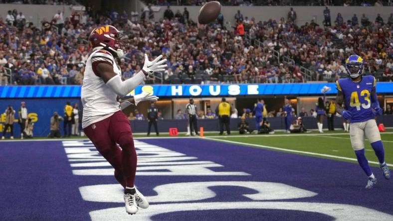 Dec 17, 2023; Inglewood, California, USA; Washington Commanders wide receiver Curtis Samuel (4) catches a touchdown pass in the second half against the Los Angeles Rams at SoFi Stadium. Mandatory Credit: Kirby Lee-USA TODAY Sports