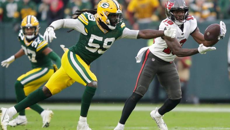 Tampa Bay Buccaneers wide receiver David Moore (19) breaks away from Green Bay Packers linebacker De'Vondre Campbell (59) for a 52-yard touchdown reception during their football game Sunday, December 17, 2023, at Lambeau Field in Green Bay, Wis.