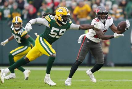 Tampa Bay Buccaneers wide receiver David Moore (19) breaks away from Green Bay Packers linebacker De'Vondre Campbell (59) for a 52-yard touchdown reception during their football game Sunday, December 17, 2023, at Lambeau Field in Green Bay, Wis.