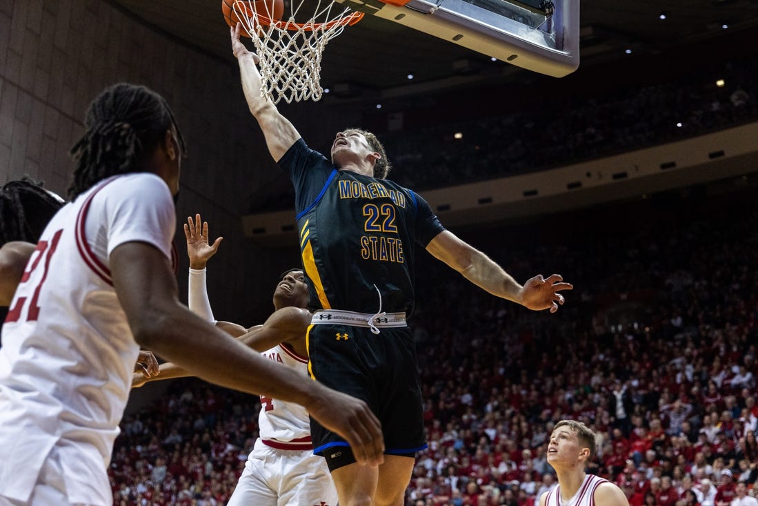 Dec 19, 2023; Bloomington, Indiana, USA; Morehead State Eagles guard Riley Minix (22) shoots the ball while Indiana Hoosiers forward Anthony Walker (4) defends in the second half at Simon Skjodt Assembly Hall. Mandatory Credit: Trevor Ruszkowski-USA TODAY Sports