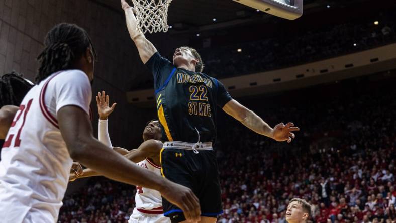 Dec 19, 2023; Bloomington, Indiana, USA; Morehead State Eagles guard Riley Minix (22) shoots the ball while Indiana Hoosiers forward Anthony Walker (4) defends in the second half at Simon Skjodt Assembly Hall. Mandatory Credit: Trevor Ruszkowski-USA TODAY Sports