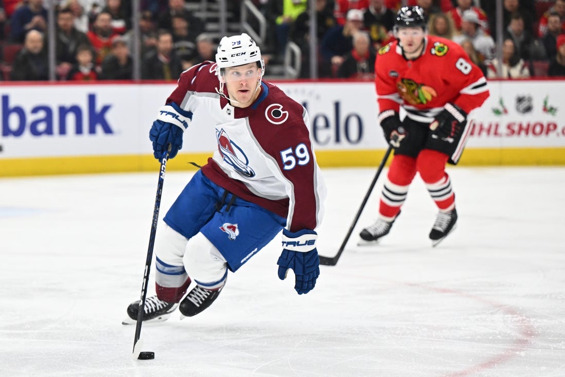 Dec 19, 2023; Chicago, Illinois, USA; Colorado Avalanche forward Ben Meyers (59) controls the puck in the first period against the Chicago Blackhawks at United Center. Mandatory Credit: Jamie Sabau-USA TODAY Sports