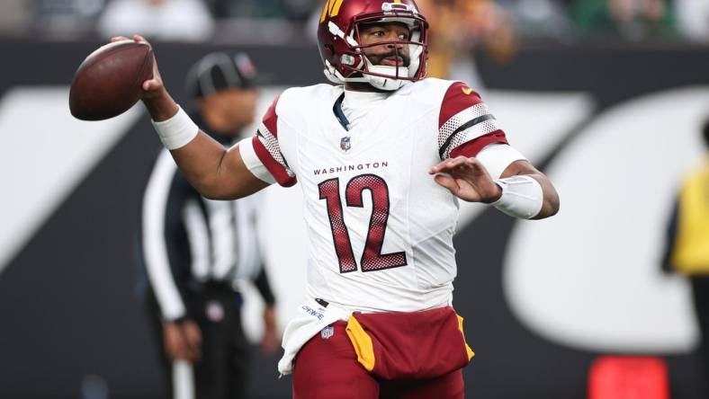 Dec 24, 2023; East Rutherford, New Jersey, USA; Washington Commanders quarterback Jacoby Brissett (12) throws the ball during the second half against the New York Jets at MetLife Stadium. Mandatory Credit: Vincent Carchietta-USA TODAY Sports