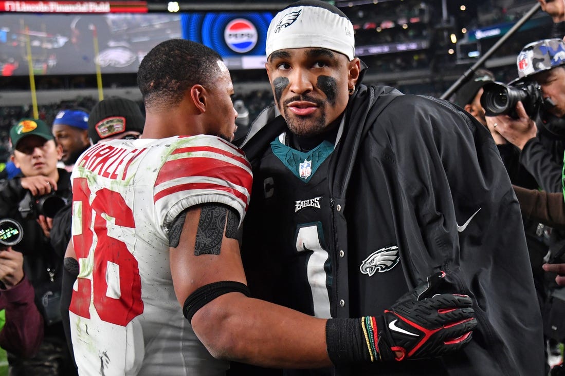 Dec 25, 2023; Philadelphia, Pennsylvania, USA; New York Giants running back Saquon Barkley (26) and Philadelphia Eagles quarterback Jalen Hurts (1) after game at Lincoln Financial Field. Mandatory Credit: Eric Hartline-USA TODAY Sports