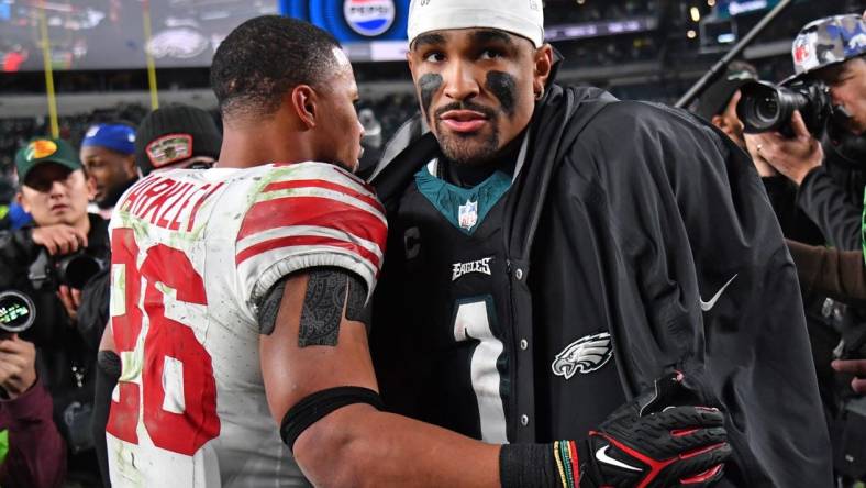 Dec 25, 2023; Philadelphia, Pennsylvania, USA; New York Giants running back Saquon Barkley (26) and Philadelphia Eagles quarterback Jalen Hurts (1) after game at Lincoln Financial Field. Mandatory Credit: Eric Hartline-USA TODAY Sports