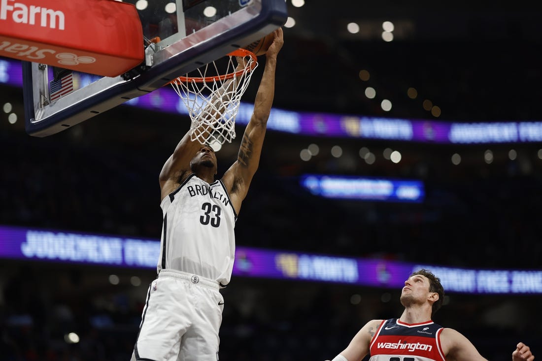 Dec 29, 2023; Washington, District of Columbia, USA; Brooklyn Nets center Nic Claxton (33) attempts to dunk the ball as Washington Wizards center Mike Muscala (35) looks on in the fourth quarter at Capital One Arena. Mandatory Credit: Geoff Burke-USA TODAY Sports
