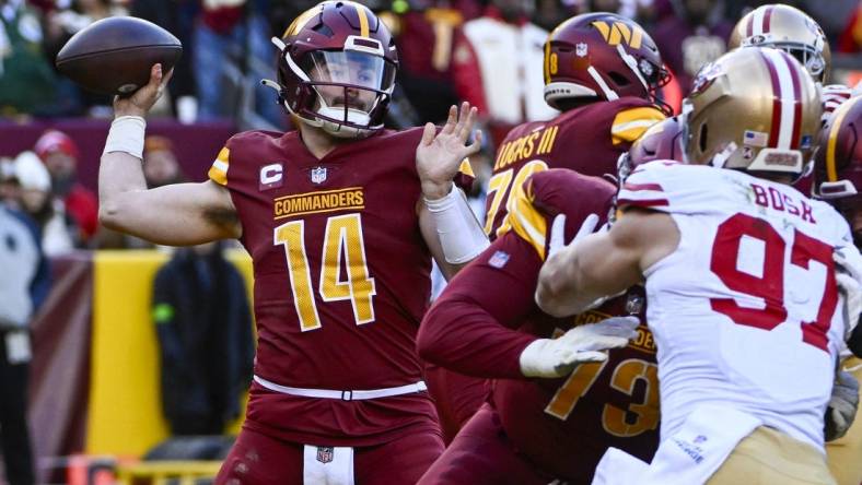 Dec 31, 2023; Landover, Maryland, USA; Washington Commanders quarterback Sam Howell (14) attempts a pass against the San Francisco 49ers during the second half at FedExField. Mandatory Credit: Brad Mills-USA TODAY Sports