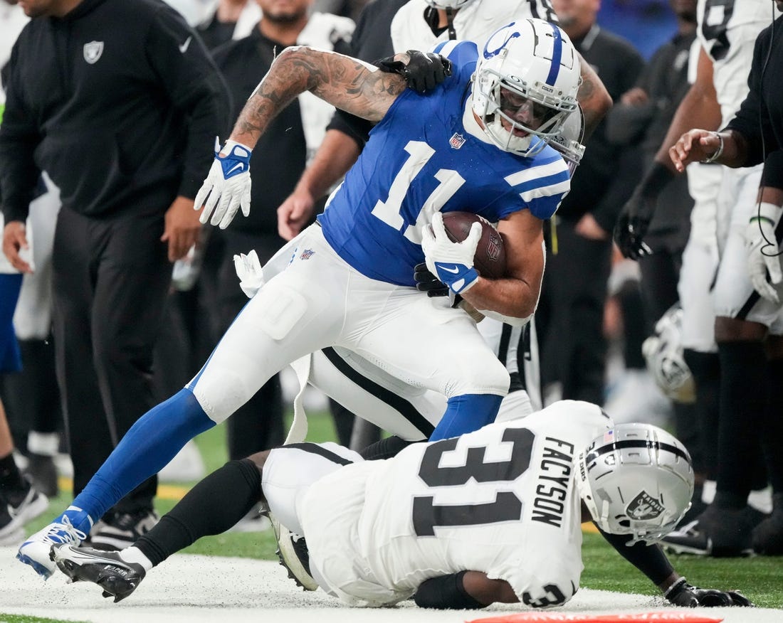 Indianapolis Colts wide receiver Michael Pittman Jr. (11) runs out of bounds as Las Vegas Raiders cornerback Brandon Facyson (31) rolls at his feet Sunday, Dec. 31, 2023, during a game against the Las Vegas Raiders at Lucas Oil Stadium in Indianapolis.