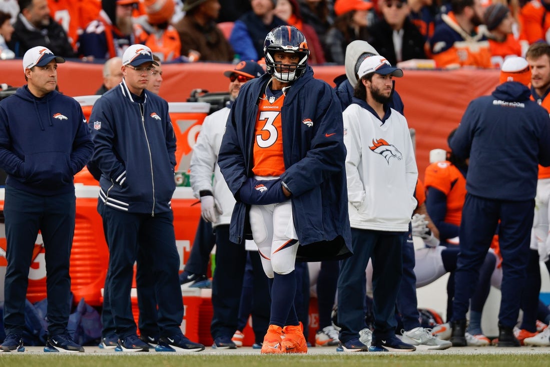 Dec 31, 2023; Denver, Colorado, USA; Denver Broncos quarterback Russell Wilson (3) looks on from the sideline in the first quarter against the Los Angeles Chargers at Empower Field at Mile High. Mandatory Credit: Isaiah J. Downing-USA TODAY Sports