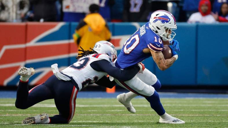 Buffalo Bills wide receiver Khalil Shakir (10) is tackled by New England Patriots safety Kyle Dugger (23) after a catch.