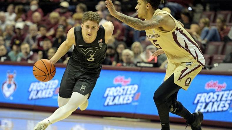 Jan 6, 2024; Tallahassee, Florida, USA; Virginia Tech Hokies guard Sean Pedulla (3) drives past Florida State Seminoles forward De Ante Green (5) during the first half at Donald L. Tucker Center. Mandatory Credit: Melina Myers-USA TODAY Sports