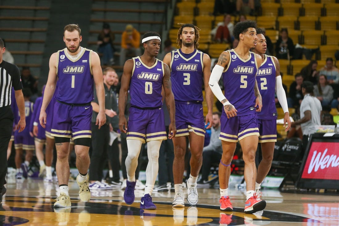 Jan 6, 2024; Hattiesburg, Mississippi, USA; James Madison Dukes players Noah Freidel (1), Xavier Brown (0), T.J. Bickerstaff (3), Terrence Edwards Jr. (5), and Raekwon Horton (2) after a timeout during the second half of their game against the Southern Miss Golden Eagles at Reed Green Coliseum. Mandatory Credit: Chuck Cook-USA TODAY Sports