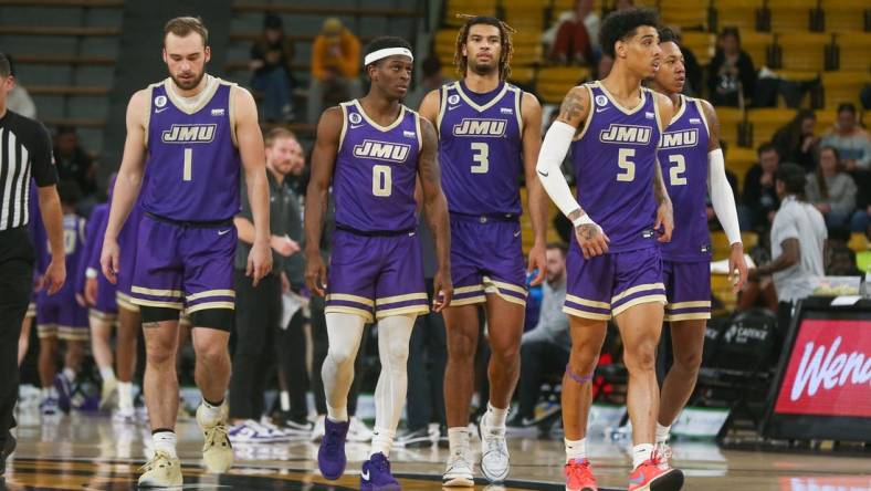 Jan 6, 2024; Hattiesburg, Mississippi, USA; James Madison Dukes players Noah Freidel (1), Xavier Brown (0), T.J. Bickerstaff (3), Terrence Edwards Jr. (5), and Raekwon Horton (2) after a timeout during the second half of their game against the Southern Miss Golden Eagles at Reed Green Coliseum. Mandatory Credit: Chuck Cook-USA TODAY Sports