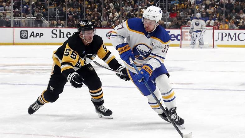 Jan 6, 2024; Pittsburgh, Pennsylvania, USA;  Buffalo Sabres center Casey Mittelstadt (37) skates with the puck against Pittsburgh Penguins center Noel Acciari (55) during the second period at PPG Paints Arena. Buffalo won 3-1. Mandatory Credit: Charles LeClaire-USA TODAY Sports