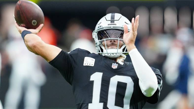 Jan 7, 2024; Paradise, Nevada, USA; Las Vegas Raiders quarterback Jimmy Garoppolo (10) warms up before a game against the Denver Broncos at Allegiant Stadium. Mandatory Credit: Stephen R. Sylvanie-USA TODAY Sports