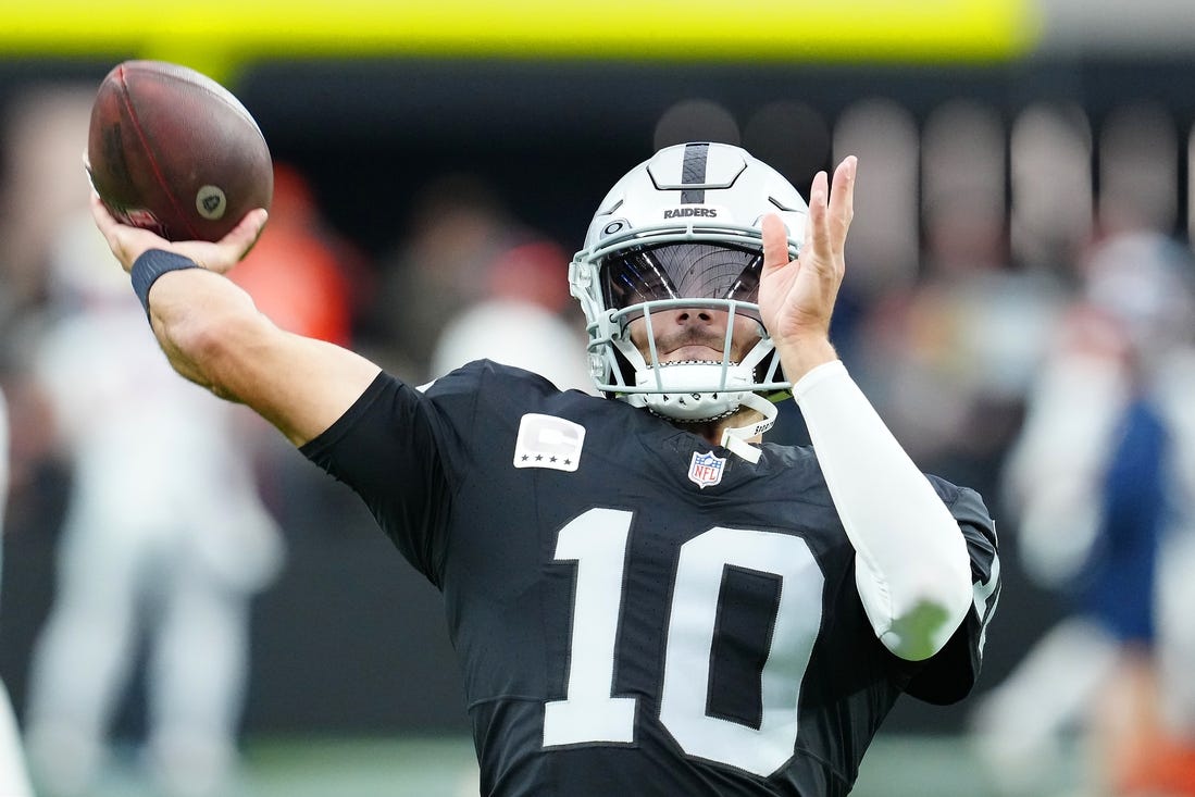 Jan 7, 2024; Paradise, Nevada, USA; Las Vegas Raiders quarterback Jimmy Garoppolo (10) warms up before a game against the Denver Broncos at Allegiant Stadium. Mandatory Credit: Stephen R. Sylvanie-USA TODAY Sports