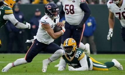 Chicago Bears quarterback Justin Fields (1) runs for a first down during the first quarter of their game against the Green Bay Packers Sunday, January 7, 2024 at Lambeau Field in Green Bay, Wisconsin.Mark Hoffman/Milwaukee Journal Sentinel