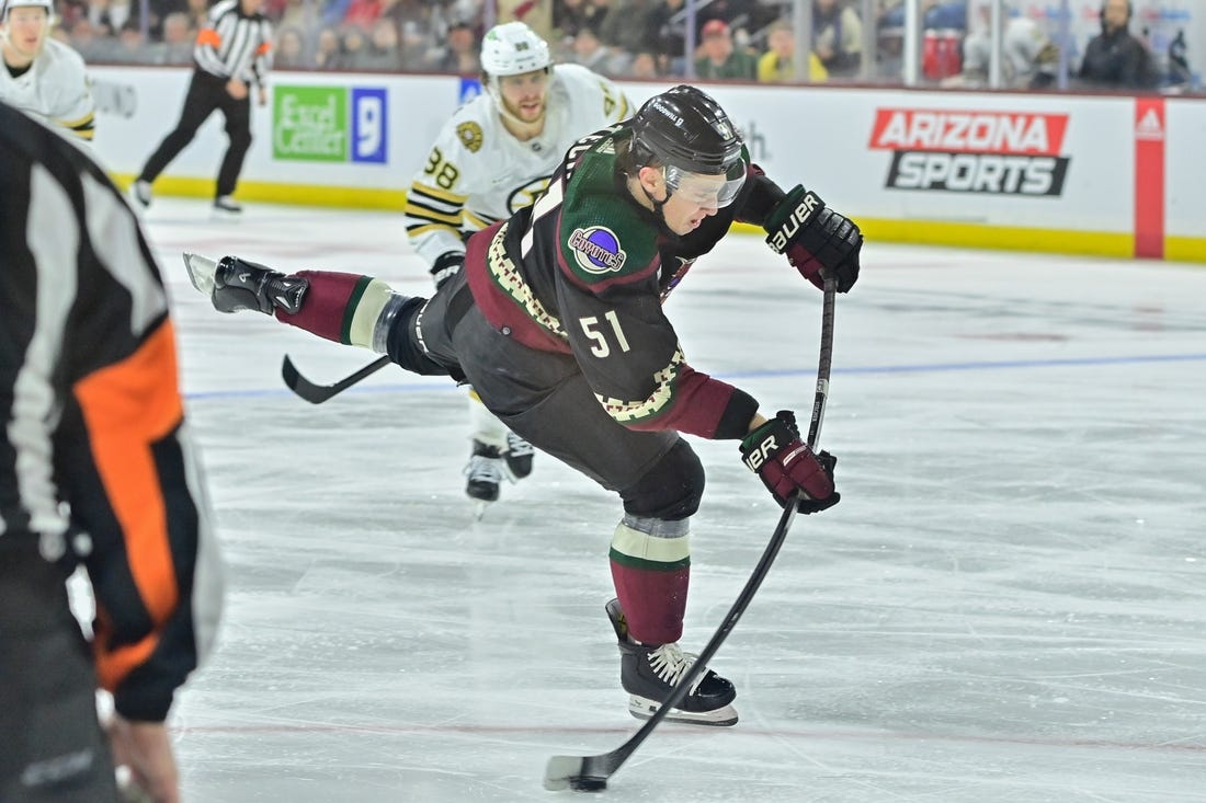 Jan 9, 2024; Tempe, Arizona, USA; Arizona Coyotes defenseman Troy Stecher (51) shoots the puck in the second period against the Boston Bruins at Mullett Arena. Mandatory Credit: Matt Kartozian-USA TODAY Sports