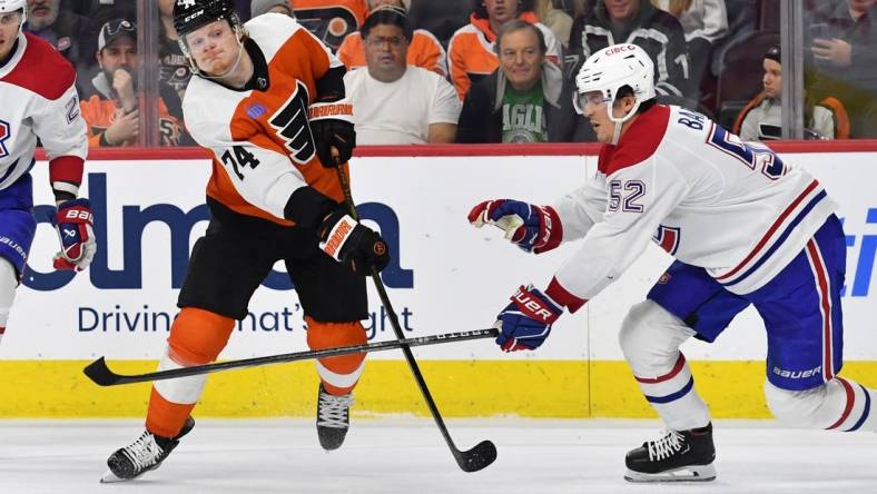 Jan 10, 2024; Philadelphia, Pennsylvania, USA; Philadelphia Flyers right wing Owen Tippett (74) takes a shot on goal against Montreal Canadiens defenseman Justin Barron (52) during third period at Wells Fargo Center. Mandatory Credit: Eric Hartline-USA TODAY Sports