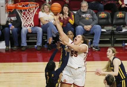 Iowa State Cyclones center Audi Crooks (55) takes a shot between West Virginia Mountaineers guard Jordan Harrison (10) and forward Kylee Blacksten (14) during the third quarter in the Big-12 conference matchup at Hilton Coliseum on Wednesday, Jan. 10, 2024, in Ames, Iowa.