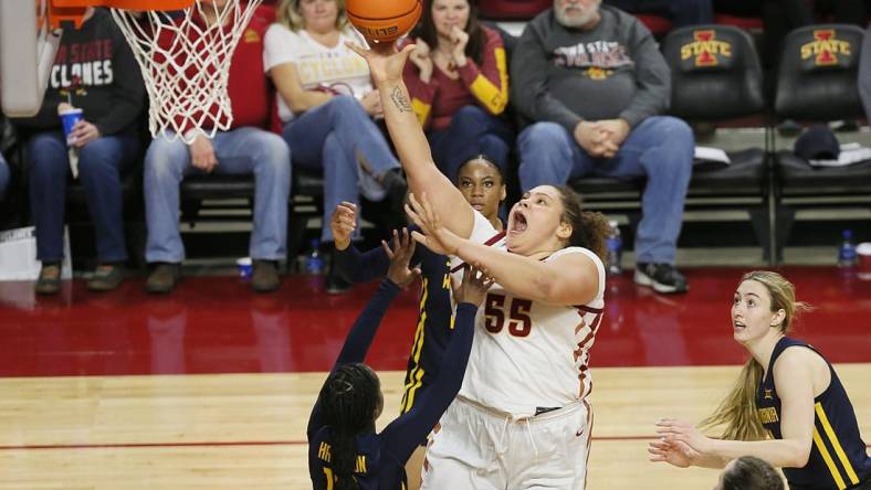 Iowa State Cyclones center Audi Crooks (55) takes a shot between West Virginia Mountaineers guard Jordan Harrison (10) and forward Kylee Blacksten (14) during the third quarter in the Big-12 conference matchup at Hilton Coliseum on Wednesday, Jan. 10, 2024, in Ames, Iowa.