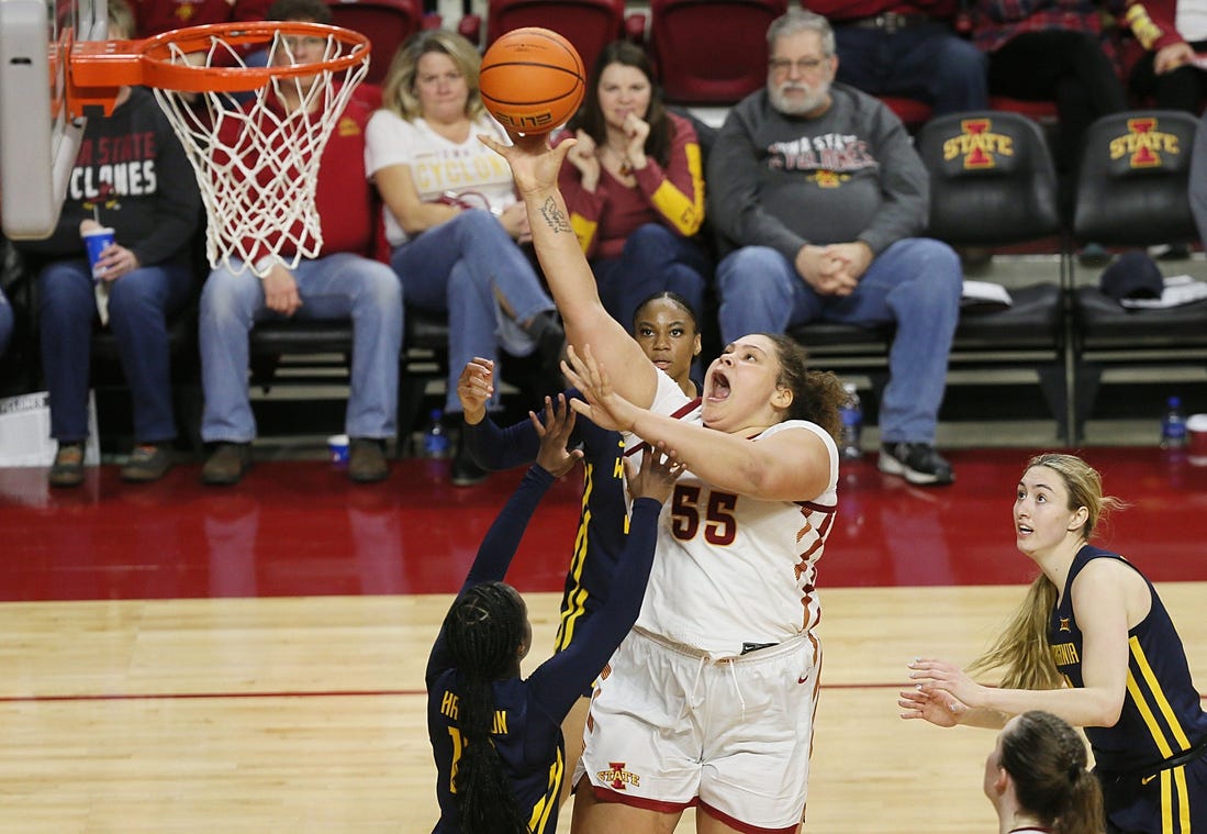 Iowa State Cyclones center Audi Crooks (55) takes a shot between West Virginia Mountaineers guard Jordan Harrison (10) and forward Kylee Blacksten (14) during the third quarter in the Big-12 conference matchup at Hilton Coliseum on Wednesday, Jan. 10, 2024, in Ames, Iowa.