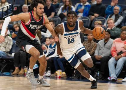 Jan 12, 2024; Minneapolis, Minnesota, USA; Minnesota Timberwolves guard Shake Milton (18) is defended by Portland Trail Blazers forward Justin Minaya (24) in the fourth quarter at Target Center. Mandatory Credit: Matt Blewett-USA TODAY Sports