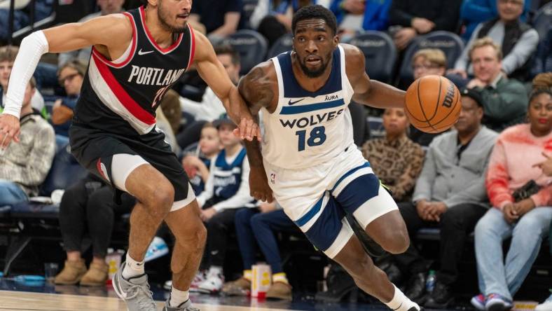 Jan 12, 2024; Minneapolis, Minnesota, USA; Minnesota Timberwolves guard Shake Milton (18) is defended by Portland Trail Blazers forward Justin Minaya (24) in the fourth quarter at Target Center. Mandatory Credit: Matt Blewett-USA TODAY Sports