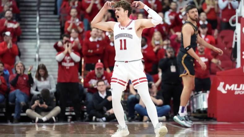 Jan 13, 2024; Madison, Wisconsin, USA; Wisconsin Badgers guard Max Klesmit (11) gestures making a three point basket during the second half at the Kohl Center. Mandatory Credit: Kayla Wolf-USA TODAY Sports