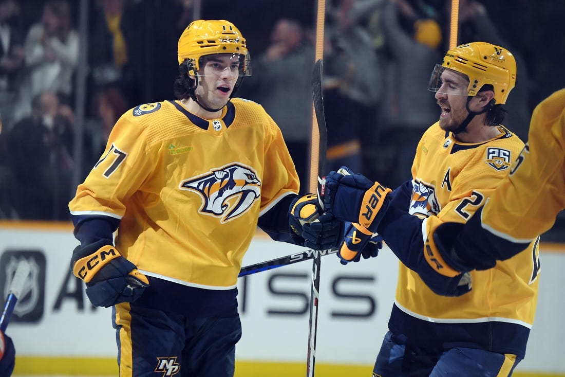 Jan 13, 2024; Nashville, Tennessee, USA; Nashville Predators right wing Luke Evangelista (77) celebrates with /defenseman Ryan McDonagh (27) after scoring during the third period against the New York Islanders at Bridgestone Arena. Mandatory Credit: Christopher Hanewinckel-USA TODAY Sports