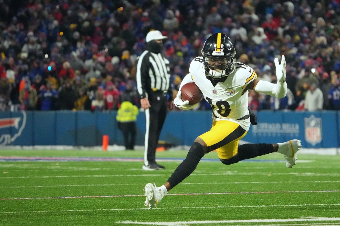 Jan 15, 2024; Orchard Park, New York, USA; Pittsburgh Steelers wide receiver Diontae Johnson (18) runs the ball in the second half against the Buffalo Bills in a 2024 AFC wild card game at Highmark Stadium. Mandatory Credit: Kirby Lee-USA TODAY Sports