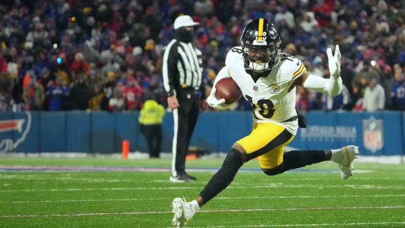 Jan 15, 2024; Orchard Park, New York, USA; Pittsburgh Steelers wide receiver Diontae Johnson (18) runs the ball in the second half against the Buffalo Bills in a 2024 AFC wild card game at Highmark Stadium. Mandatory Credit: Kirby Lee-USA TODAY Sports