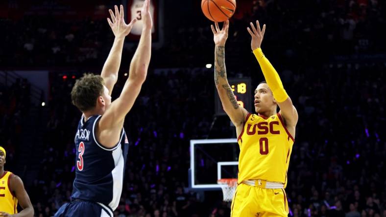 Jan 17, 2024; Tucson, Arizona, USA; USC Trojans guard Kobe Johnson (0) shoots a basket against Arizona Wildcats guard Pelle Larsson (3) during the first half at McKale Center. Mandatory Credit: Zachary BonDurant-USA TODAY Sports