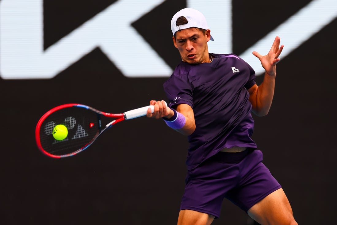 Jan 19, 2024; Melbourne, Victoria, Australia; Sebastian Baez of Argentina plays a shot against Jannik Sinner (not pictured) of Italy in Round 3 of the Men's Singles on Day 6 of the Australian Open tennis at Margaret Court Arena. Mandatory Credit: Mike Frey-USA TODAY Sports