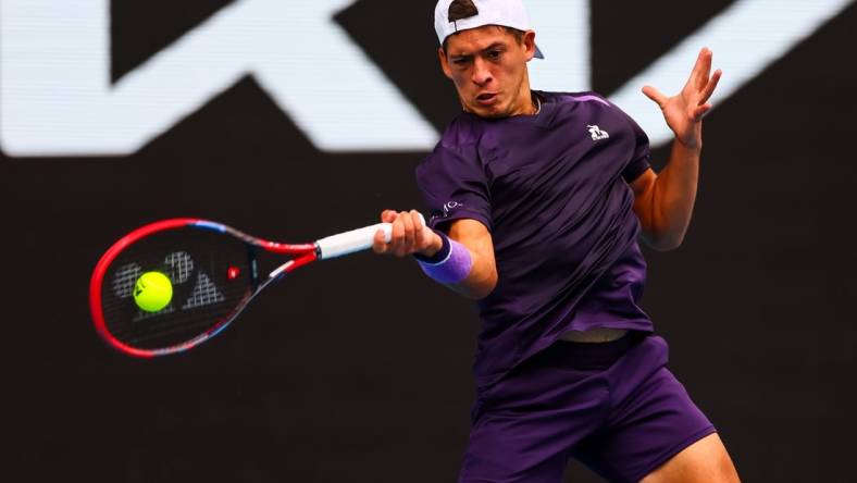 Jan 19, 2024; Melbourne, Victoria, Australia; Sebastian Baez of Argentina plays a shot against Jannik Sinner (not pictured) of Italy in Round 3 of the Men's Singles on Day 6 of the Australian Open tennis at Margaret Court Arena. Mandatory Credit: Mike Frey-USA TODAY Sports