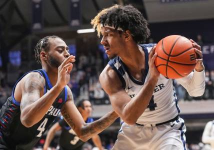 Butler Bulldogs guard DJ Davis (4) holds the ball from DePaul Blue Demons guard K.T. Raimey (4) on Saturday, Jan. 20, 2024, during the game at Hinkle Fieldhouse in Indianapolis. The Butler Bulldogs defeated the DePaul Blue Demons, 74-60.