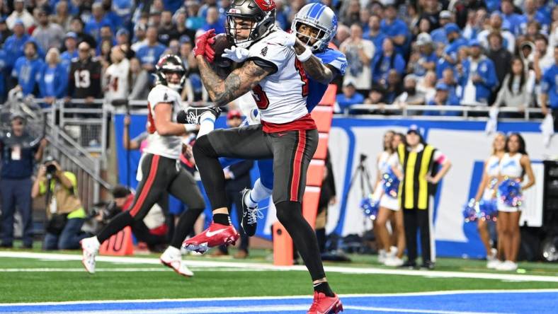 Jan 21, 2024; Detroit, Michigan, USA; Tampa Bay Buccaneers wide receiver Mike Evans (13) makes a catch against Detroit Lions cornerback Cameron Sutton (1) during the second half in a 2024 NFC divisional round game at Ford Field. Mandatory Credit: Lon Horwedel-USA TODAY Sports