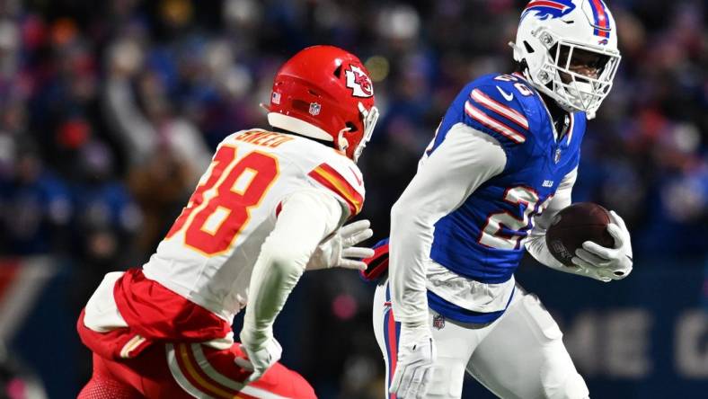 Jan 21, 2024; Orchard Park, New York, USA; Buffalo Bills running back Latavius Murray (28) rushes the ball against  Kansas City Chiefs cornerback L'Jarius Sneed (38)in the first half of the 2024 AFC divisional round game at Highmark Stadium. Mandatory Credit: Mark Konezny-USA TODAY Sports