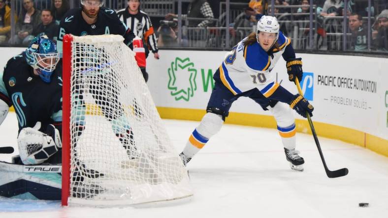 Jan 26, 2024; Seattle, Washington, USA; St. Louis Blues center Oskar Sundqvist (70) plays the puck behind the goal against the Seattle Kraken during the first period at Climate Pledge Arena. Mandatory Credit: Steven Bisig-USA TODAY Sports