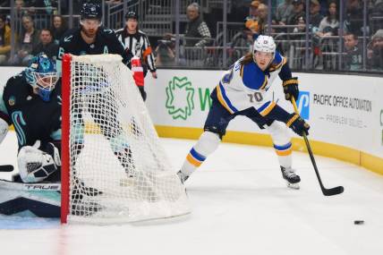 Jan 26, 2024; Seattle, Washington, USA; St. Louis Blues center Oskar Sundqvist (70) plays the puck behind the goal against the Seattle Kraken during the first period at Climate Pledge Arena. Mandatory Credit: Steven Bisig-USA TODAY Sports
